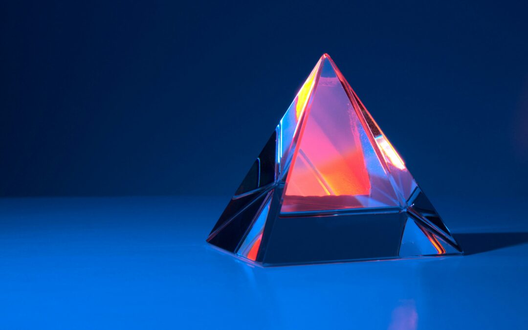 A glass pyramid with light reflecting in the pyramid represents a shiny object