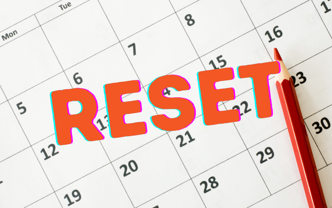 Calendar with red stamp on it that says "RESET"
