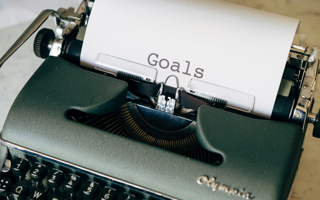 This picture of an old typewriter with the word "Goals" on the paper represents the process of goal setting, as described in the full article.