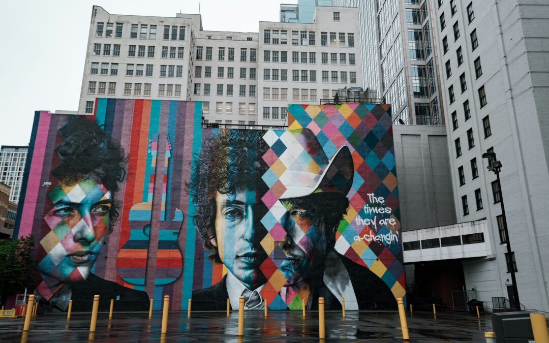 A mural on the side of the building showing three faces of Bob Dylan from his almost 70-year career. He didn't let imposter syndrome keep him from sharing his gift with the world.